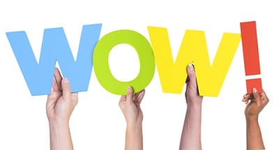 Hands holding up a "wow!" response to great pharmacy customer service